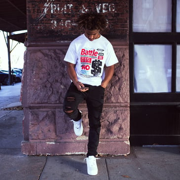 athlete hanging out wearing a battle football t-shirt