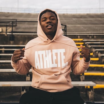 A male athlete wearing ATHLETE hoodie by Battle Sports