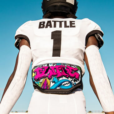 Football player wearing Battle Sports football back plate