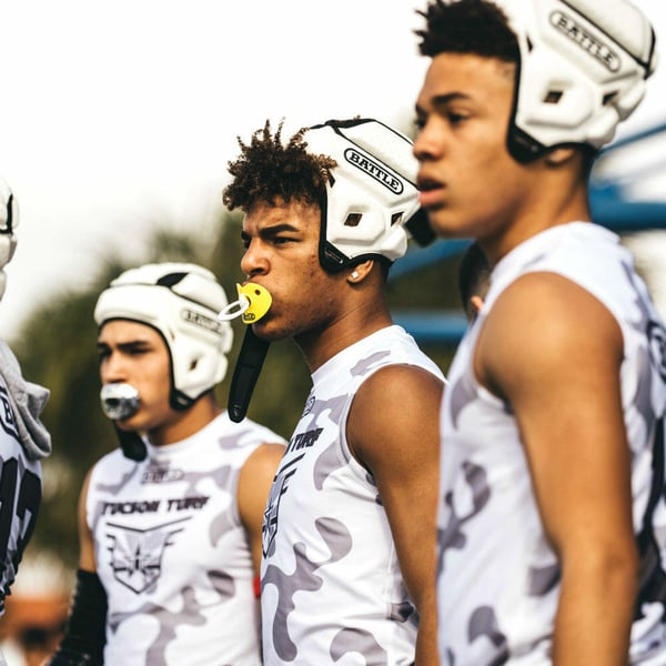 football players wearing softshell helmets