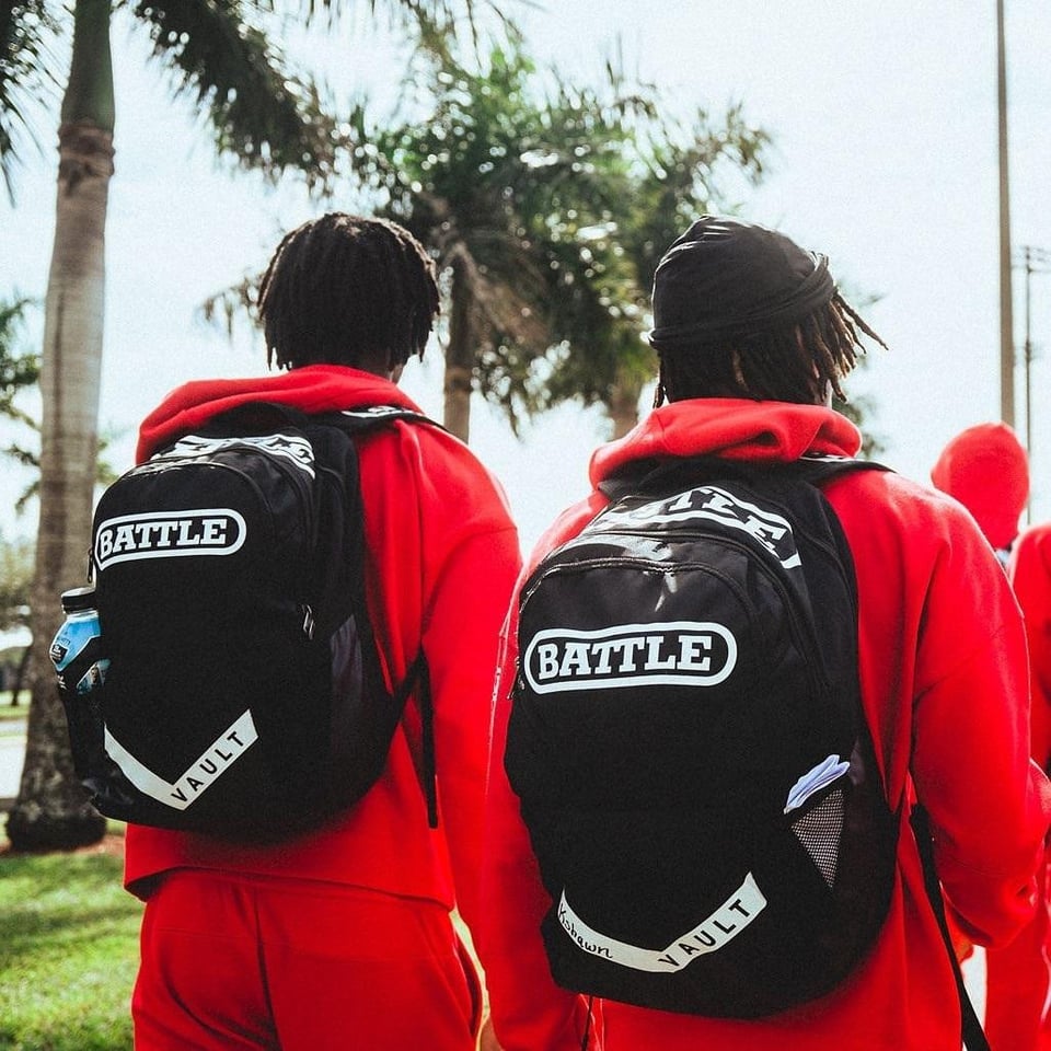 Two boys wearing battle sports football backpacks