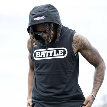 Male athlete wearing a black Battle Sports Sleeveless Action Hoodie